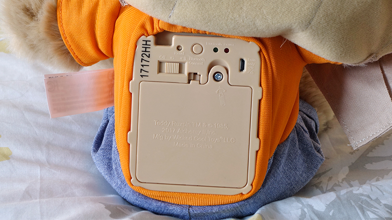 Removing Teddy Ruxpin’s vest reveals a battery door hidden on his back, as well as power and Bluetooth switches.